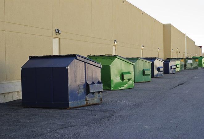 multiple construction dumpsters at a worksite holding various types of debris in Fayetteville